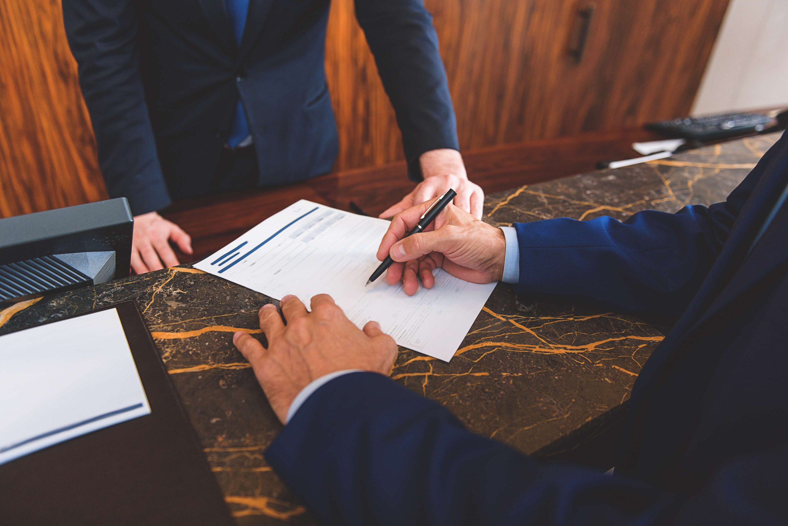 Businessman with pen completing blank