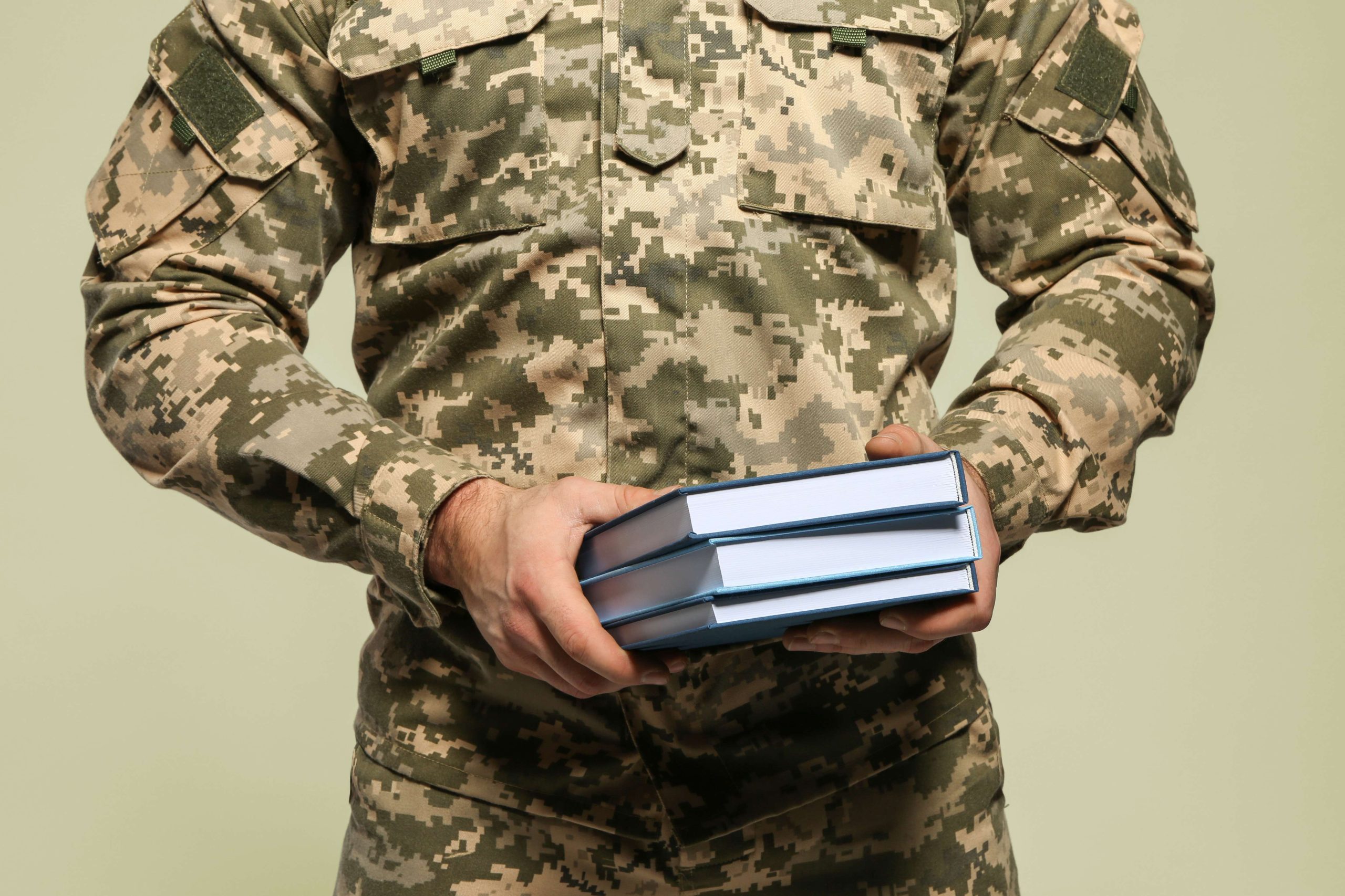 Cadet of military school on grey background, closeup