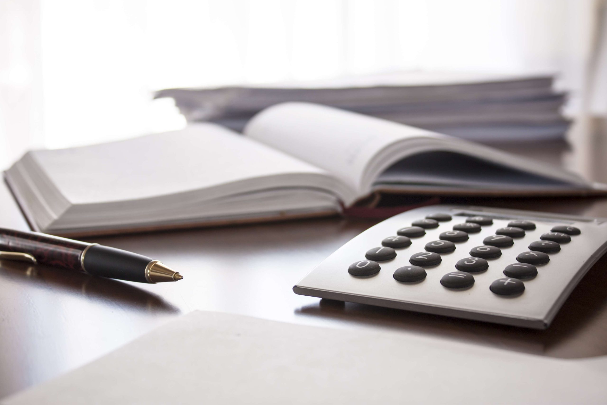 planner with  pen and calculator on the table